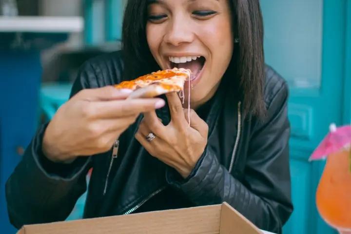 woman eating pizza