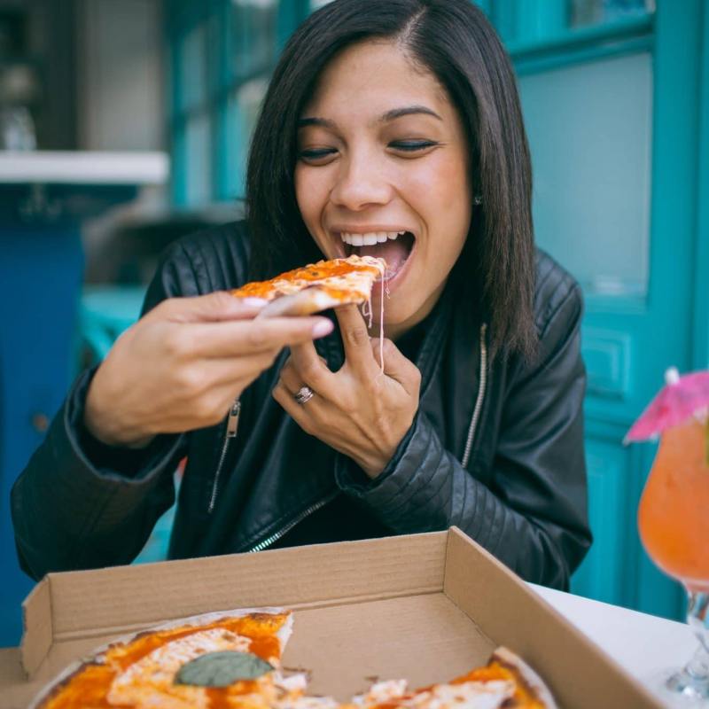 woman eating pizza